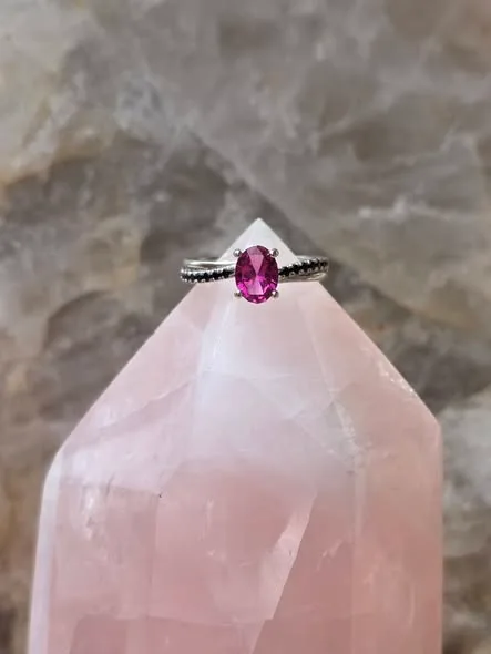 A pink Tourmaline Center, with Black Diamond Accents, and set in Sterling Silver.