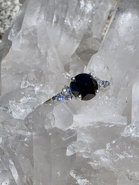 A beautiful rose cut Black Diamond, surrounded by 6 Smaller diamonds, and set in sterling Silver.