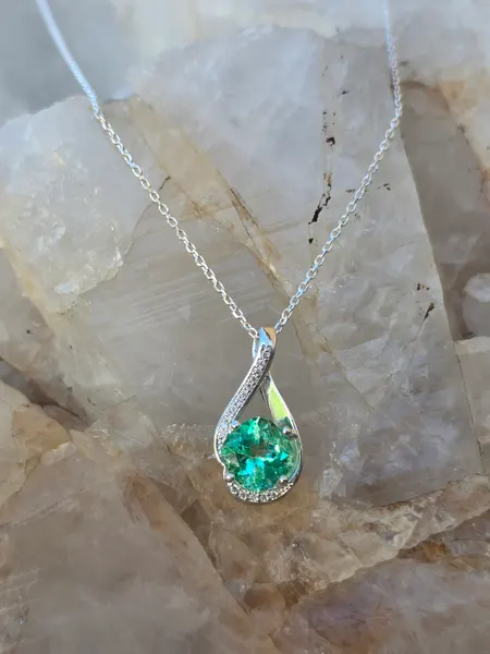 This Stunning light Green Emerald and diamond pendant is set in Sterling Silver.